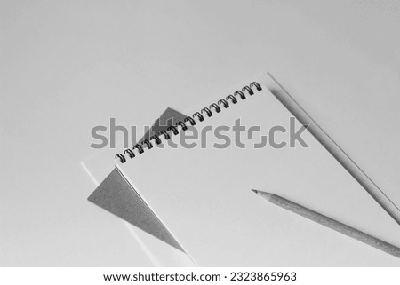 Blank Spiral Notebook Sheet with Pencil on Office Desk. Minimal Monochrome Business Mockup with Copy Space. Business Meeting.
