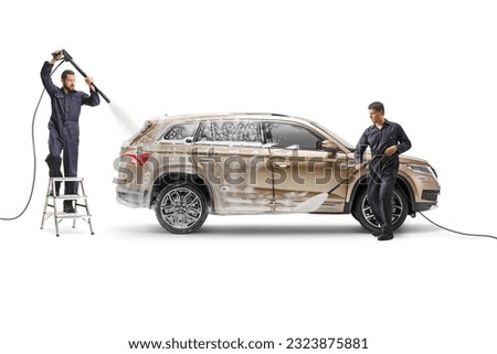 SUV at a carwash and working using water pressure machines isolated on white background