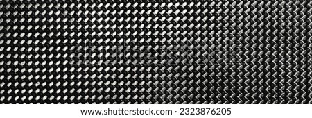 Gray grained carbon fiber background closeup macro