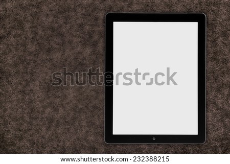 tablet pc over wood table with spoon and fork