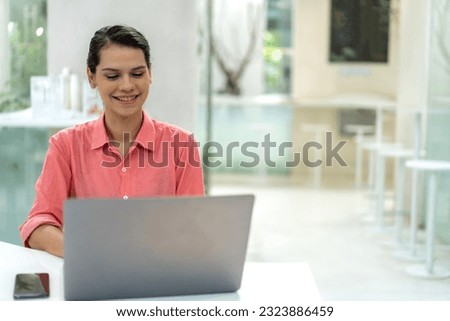 Portrait of smiling happy beautiful woman relax using technology of laptop computer sitting on chair.Young hipster creative girl freelancer business thinking with new idea content in cafe