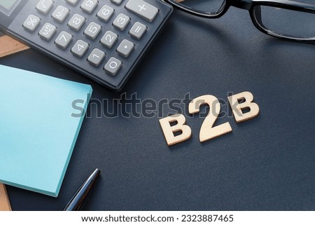 Concept of B2B with the words B2B made from wood on the black background