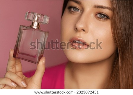 Perfume, beauty product and cosmetics model face portrait on pink background, beautiful woman holding fragrance bottle with floral feminine scent, fashion and makeup concept