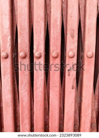 Close Up of Metal Red Harmonica Rolling  Door 