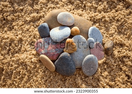 Colorful, decorative pebbles, stones on the sea sand.