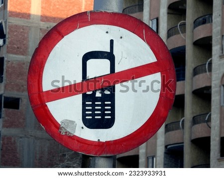 No cell phone use during driving sign, a traffic signboard shows that using a mobile phone is restricted and prohibited during driving including talking, reading and texting, selective focus