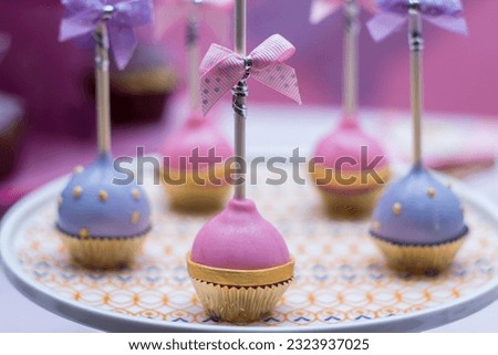 A decorative picture of lollypop or popsicle on a tray. the popsicle or lollypop are edible. 