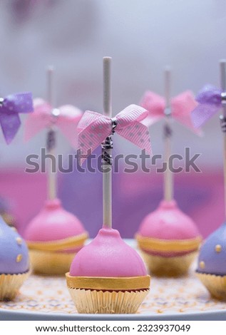 A decorative picture of lollypop or popsicle on a tray. the popsicle or lollypop are edible. 