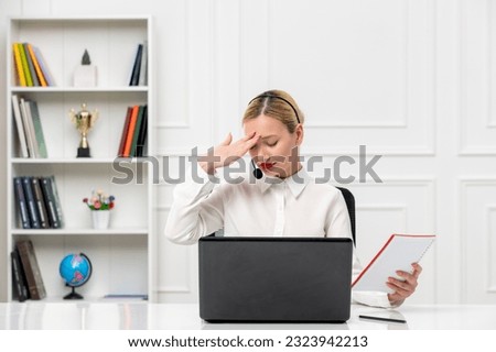 customer service cute blonde girl in office shirt with headset and computer tired