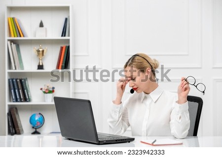 customer service cute blonde girl office shirt with headset and computer tired taking glasses of