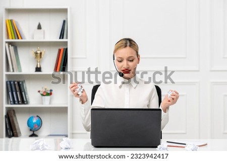 customer service cute blonde girl office shirt with headset and computer holding a crumbled paper
