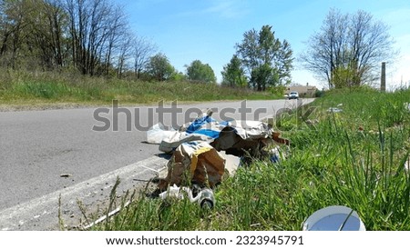 Illegal dump on the street - rudeness Royalty-Free Stock Photo #2323945791