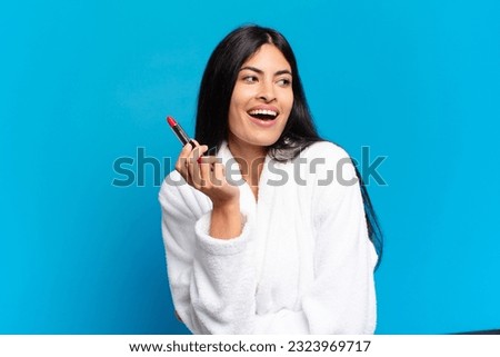young hispanic woman making up