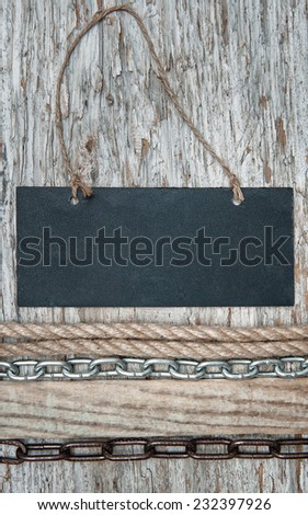Chalkboard with metal chain on the old wood 