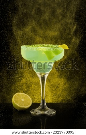 Coctail picture in bar with black background and golden glitter. Macro coctail picturewith lemon and reflective surface
