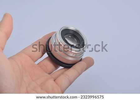 camera lens on hand on a white background