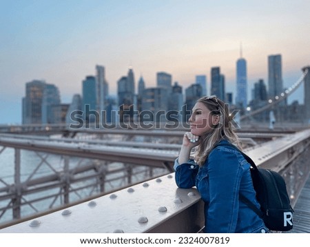 tourist woman on Brooklyn Bridge in New York