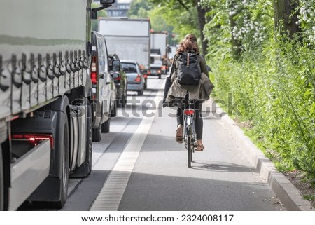 Cyclist on painted bike lane next to truck