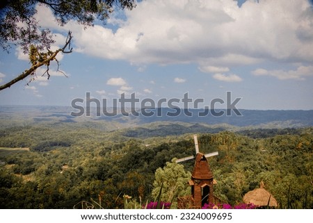 A tourist spot called Wisata Seribu Batu Songgo Langit, presenting the beauty of pine forests( hutan pinus) in the hills. there is a hobbit house garden. Royalty-Free Stock Photo #2324009695