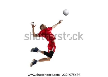 Dynamic image of young sportive man, professional volleyball player in red uniform in motion, hitting ball on white studio background. Concept of sport, active lifestyle, health, dynamics, game, ad Royalty-Free Stock Photo #2324075679