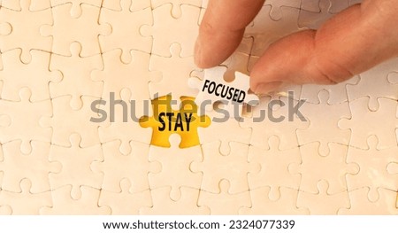Stay focused symbol. Concept words Stay focused on beautiful white puzzles on beautiful white background. Businessman hand. Business support motivation psychological stay focused concept. Copy space