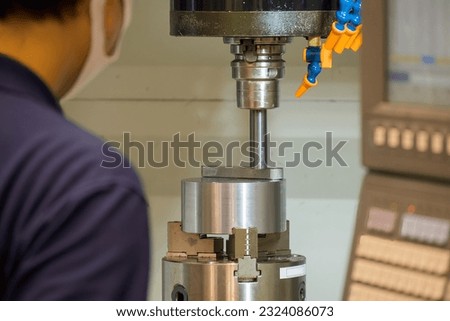 The machine operator working with CNC milling machine. The metalworking process by machining center.