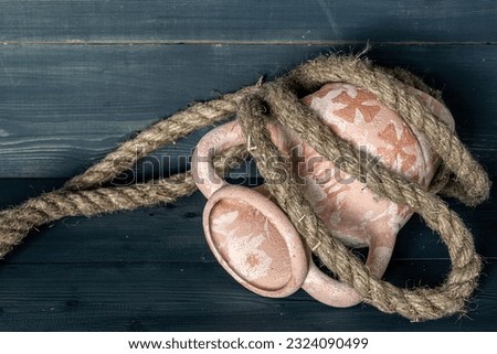 Broken amphora on a wooden table. Hemp rope. Still life. Template with copy space. Royalty-Free Stock Photo #2324090499