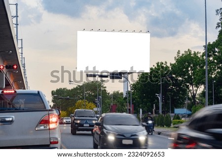 A blank billboard on one of Thailand's streets, a blank billboard with copy space for text or content, mockup of a blank billboard in a big city, evening scene. Space for your ad. Royalty-Free Stock Photo #2324092653