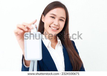 Close-up shot of an employee hand holding a name badge. of a working office woman wearing a blue suit. Business concept. Free space to write a message.