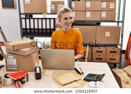 Young blonde woman ecommerce business worker using laptop working at office