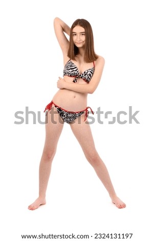 Young beautiful girl in a bathing suit isolated on a white background. High resolution photo. Full depth of field.