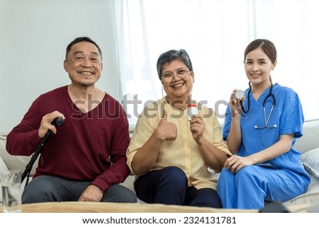 Caregiver nurse take care a Senior patient sit on sofa at home. Nurse helping senior people