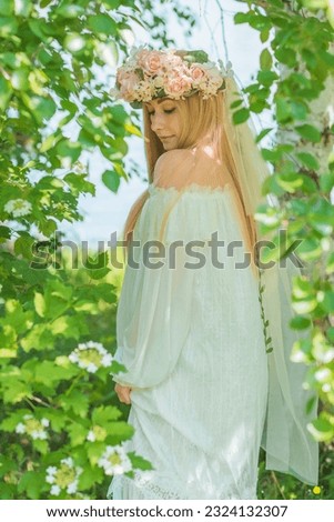 European Slavic Tradition, bride woman in white dress, flower wreath with a veil on a head. Tender girl