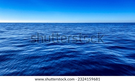Landscape of the waves of the sea in the deepest part of the ocean, it is a beautiful place on the surface where the blue color of the water mixes with the blue color of the sky. Sea and ocean concept