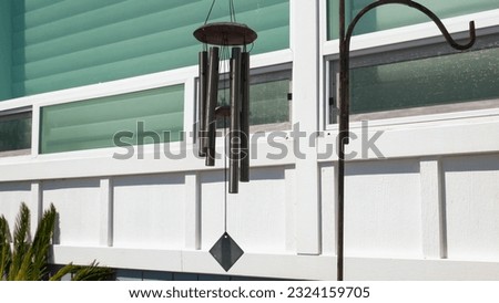 Garden bells wind chimes outdoor. Hanging home decore, close-up Royalty-Free Stock Photo #2324159705
