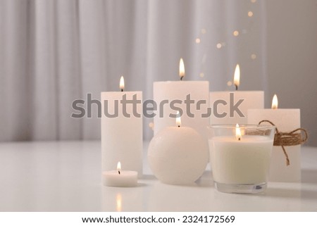 Burning scented candles for relaxing on a white wooden table