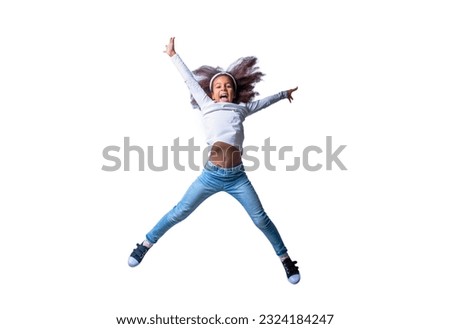 Smiling little african american kid girl jumping, having fun. Smile african child girl jumping and celebrating isolated over white background. Energetic little ethnic girl afro hairstyle, jumping.