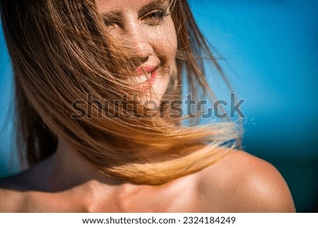 Smiling woman perfect look, bright blond hair. Natural youthful beauty. Woman flying hair enjoying, outdoor. Beauty blonde girl portrait at summer. Woman smiling perfect smile. Perfect hair, shampoo.
