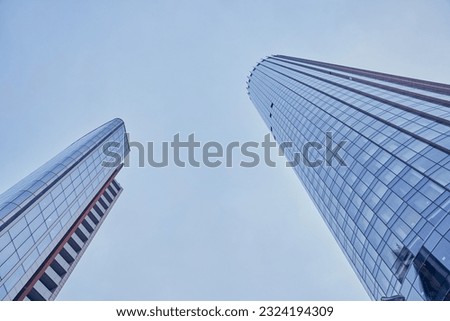 A view from below of modern skyscrapers in the business district against the blue sky. I'm looking at the business buildings in the city center. With space to copy. High quality photo