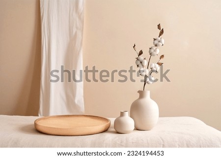 Beige ceramic vases with dry cotton branches. Stylish and minimalistic background for display your products in living room. Scandinavian interior. Modern home decor. Copy space. Royalty-Free Stock Photo #2324194453