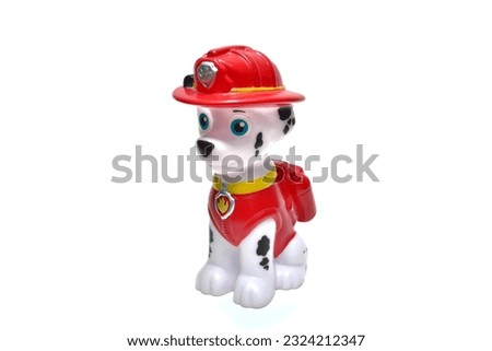 Toy, dog doll, plastic, firefighter, on a white background. Suitable for children