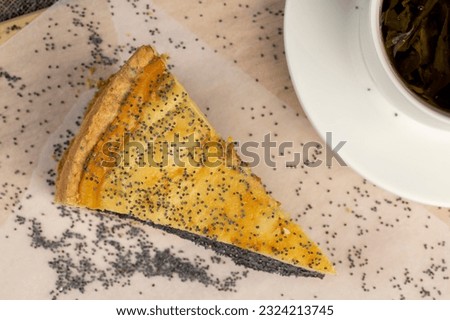 Delicious poppy seed cake with a thin sponge cake and lots of poppy seed filling, a delicious dessert of sponge cake and sweet poppy seed filling