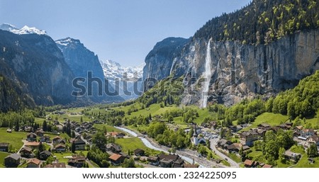 Aerial panorama image of the beautiful village Lauterbrunnen with Staubbach waterfall and snow mountain Jungfrau at the background Royalty-Free Stock Photo #2324225095