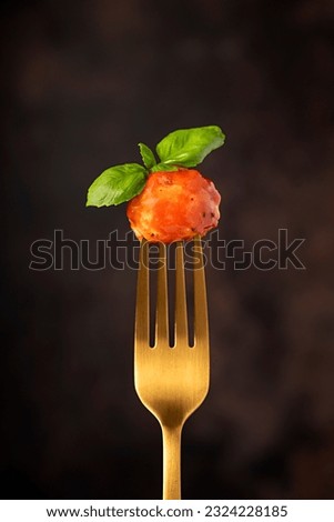 Macro food photography of meatball, chicken, beef; meat, tomato, sauce, basil, veal, fried, grilled, roasted, fork Royalty-Free Stock Photo #2324228185