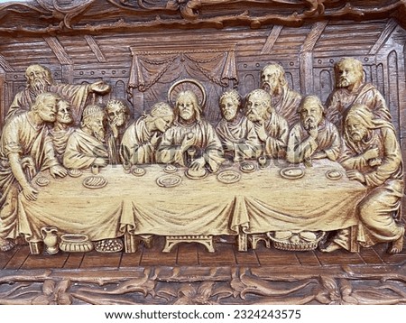 Picture of wood carving of Jesus and disciples at the last supper.