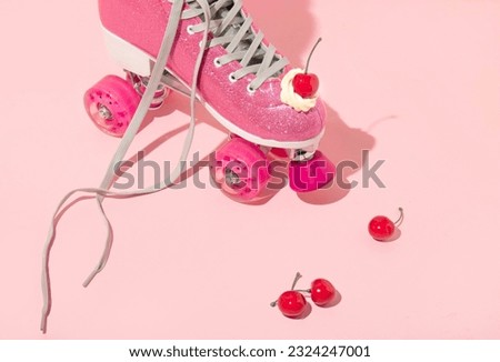 Summer creative layout with pink roller skates with whipped cream and bright red cherries bright red cherries on pastel pink background. 80s or 90s retro aesthetic idea. Minimal fashion girl idea.