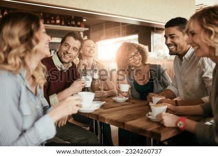 Group of young people enjoying a coffee in a cafe Royalty-Free Stock Photo #2324260737