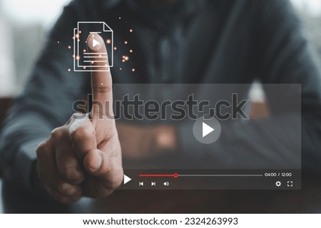 Male touching by finger on streaming online, watching a video on internet. Enjoying digital content from anywhere. Online streaming concept is ultimate entertainment solution. Learning from comfort