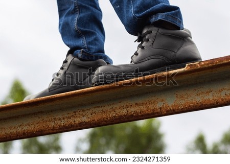 Wear safety shoes to ensure safety at work. construction workers wear safety shoes. People with factory safety concept Royalty-Free Stock Photo #2324271359