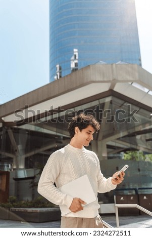 Relaxed young Latin American man using mobile phone, checking social media content, scrolling news feed, messaging, posting photos on his social account, ordering food, booking. People and technology 
